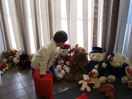 A little boy picking out a stuffed animal at the Christmas party
